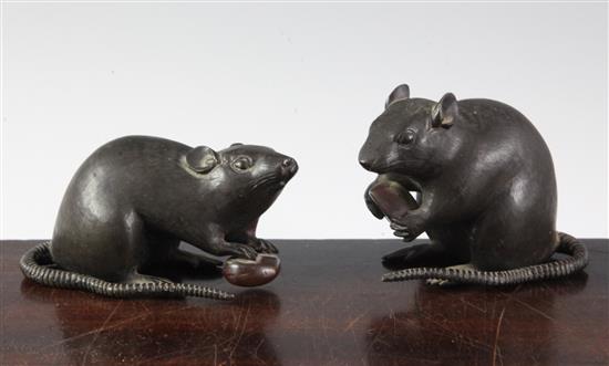 Two Japanese two-colour bronze models of a rat holding a nut, 19th century, length 9cm and 9.5cm